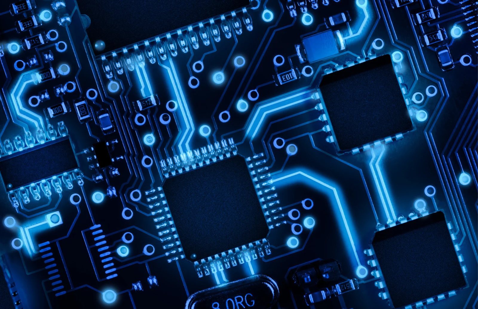 Glowing blue circuit board with processor chips and connection traces